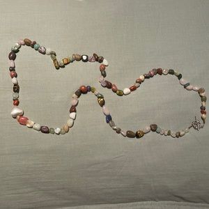 Gorgeous multi colored stones with silver plate hearts. Can be long or doubled